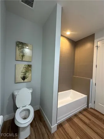a spacious bathroom with a granite countertop sink and a mirror