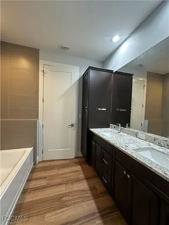 a large bathroom with double vanity and a mirror