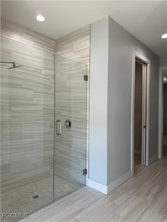 a large kitchen with stainless steel appliances a large window a sink and a counter space
