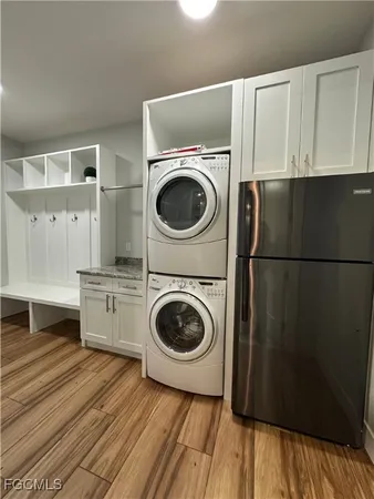 a kitchen with stainless steel appliances granite countertop a stove top oven a sink dishwasher and a refrigerator