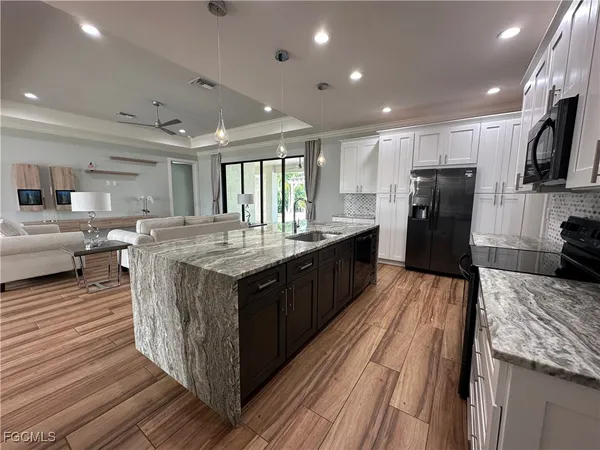 a large kitchen with a table and chairs