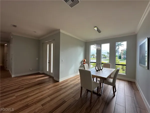 a view of a dining room with furniture window and wooden floor