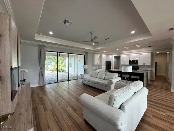 a living room with furniture and a wooden floor