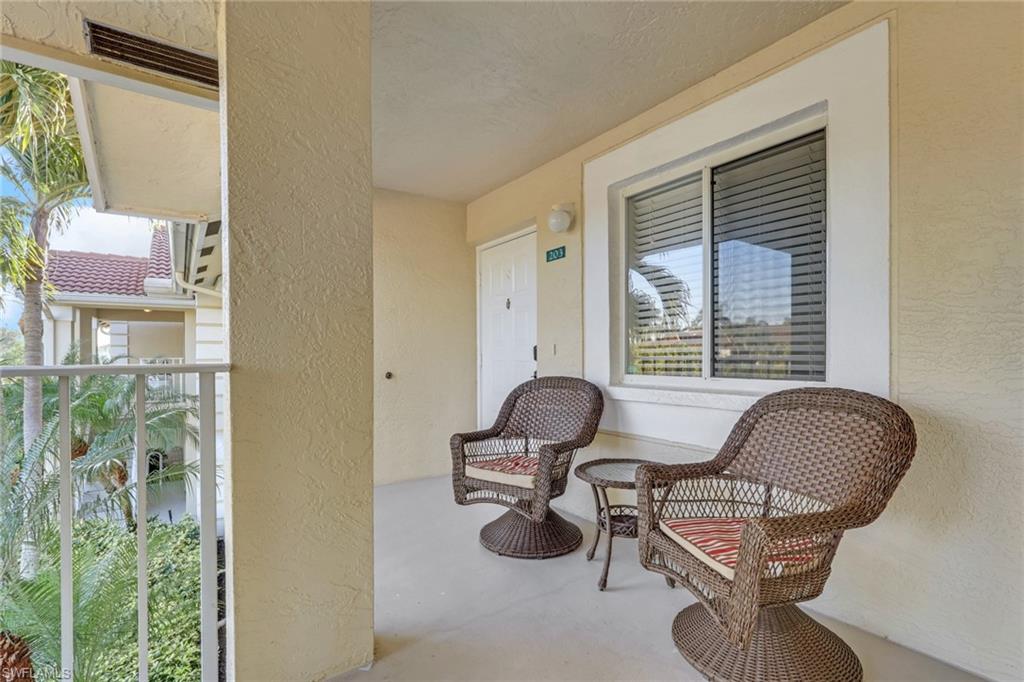 7766 Emerald Circle, Unit R203 Naples, FL 34109 - Photo 3 of 25 a living room with furniture and a window