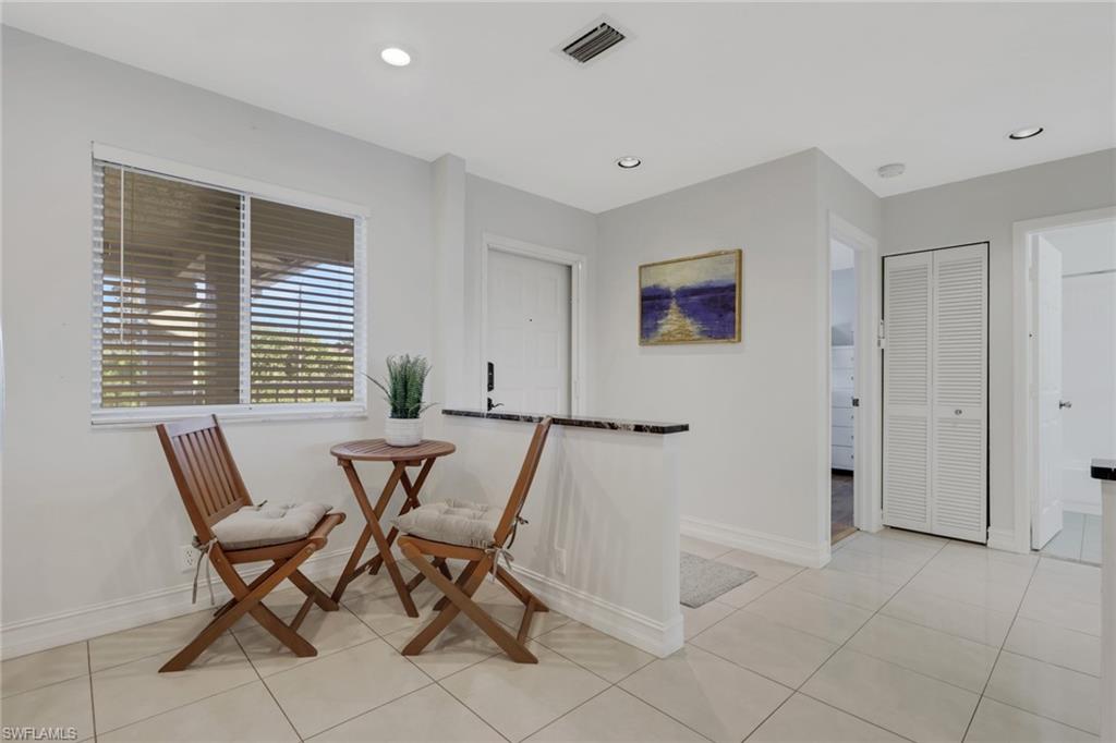 7766 Emerald Circle, Unit R203 Naples, FL 34109 - Photo 5 of 25 a view of a dining room with furniture and a window