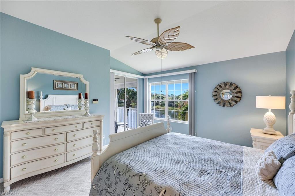 10751 Halfmoon Shoal Road, Unit 201 Estero, FL 34135 - Photo 15 of 47 Primary bedroom with lots of natural light, carpeted flooring and beautiful views of the fountains and lake with private entrance to the patio.