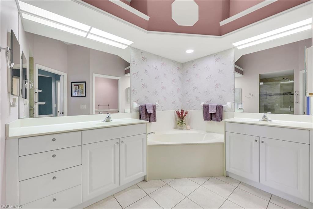 10751 Halfmoon Shoal Road, Unit 201 Estero, FL 34135 - Photo 16 of 47 Primary bathroom with double vanity, garden tub, shower and water closet.