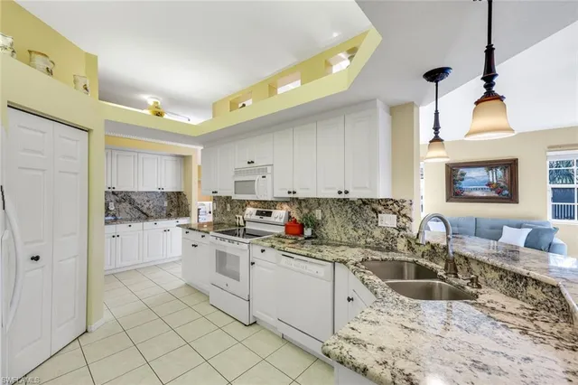 a kitchen with a sink cabinets and window