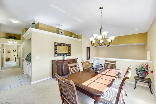 a dining room with furniture and chandelier