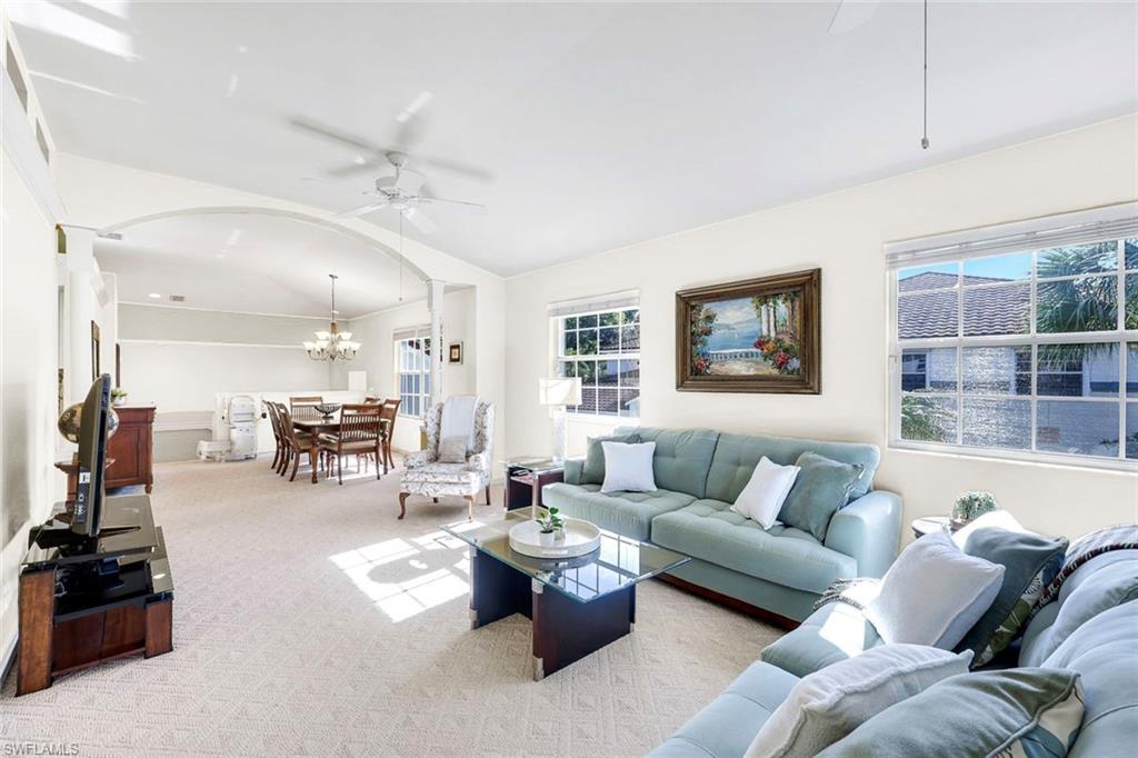 10751 Halfmoon Shoal Road, Unit 201 Estero, FL 34135 - Photo 4 of 47 (Virtual wall color change) Spacious living room with lots of natural light, dining area, and carpeted flooring.