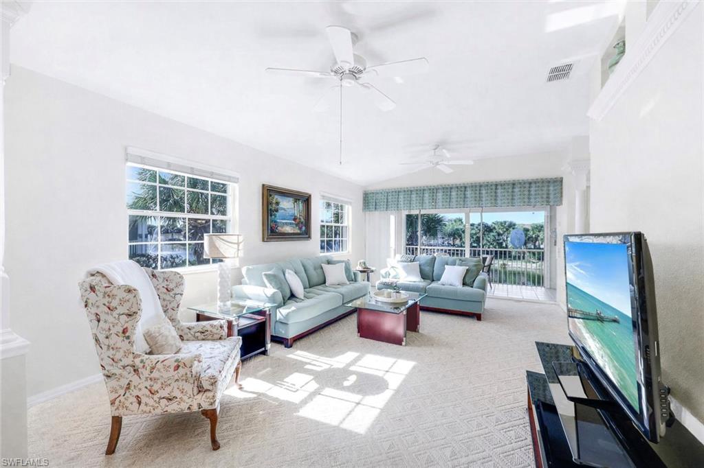 10751 Halfmoon Shoal Road, Unit 201 Estero, FL 34135 - Photo 5 of 47 (Virtual wall color change) Spacious living room with lots of natural light, carpeted flooring and beautiful view from the 2nd story overlooking the lake.