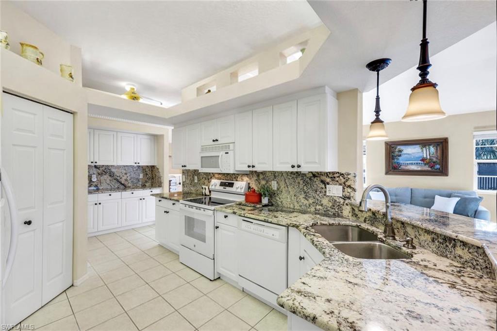 10751 Halfmoon Shoal Road, Unit 201 Estero, FL 34135 - Photo 9 of 47 (Virtual wall color change) Large kitchen with granite countertops, bar seating, plenty of cabinetry for storage and large pantry.