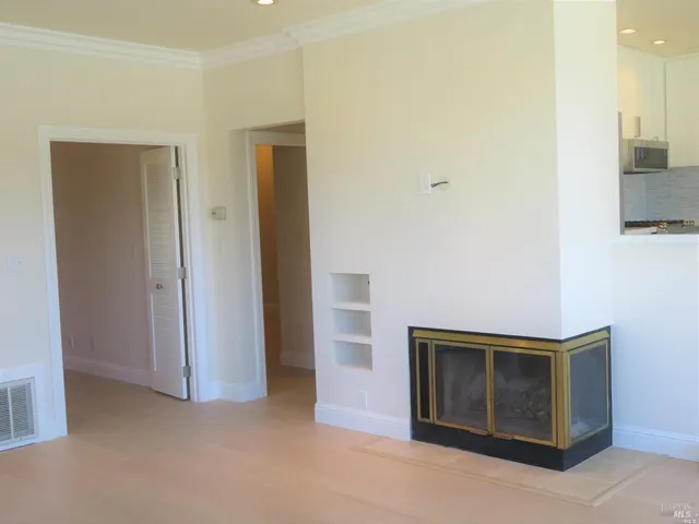 a view of an empty room and fire place