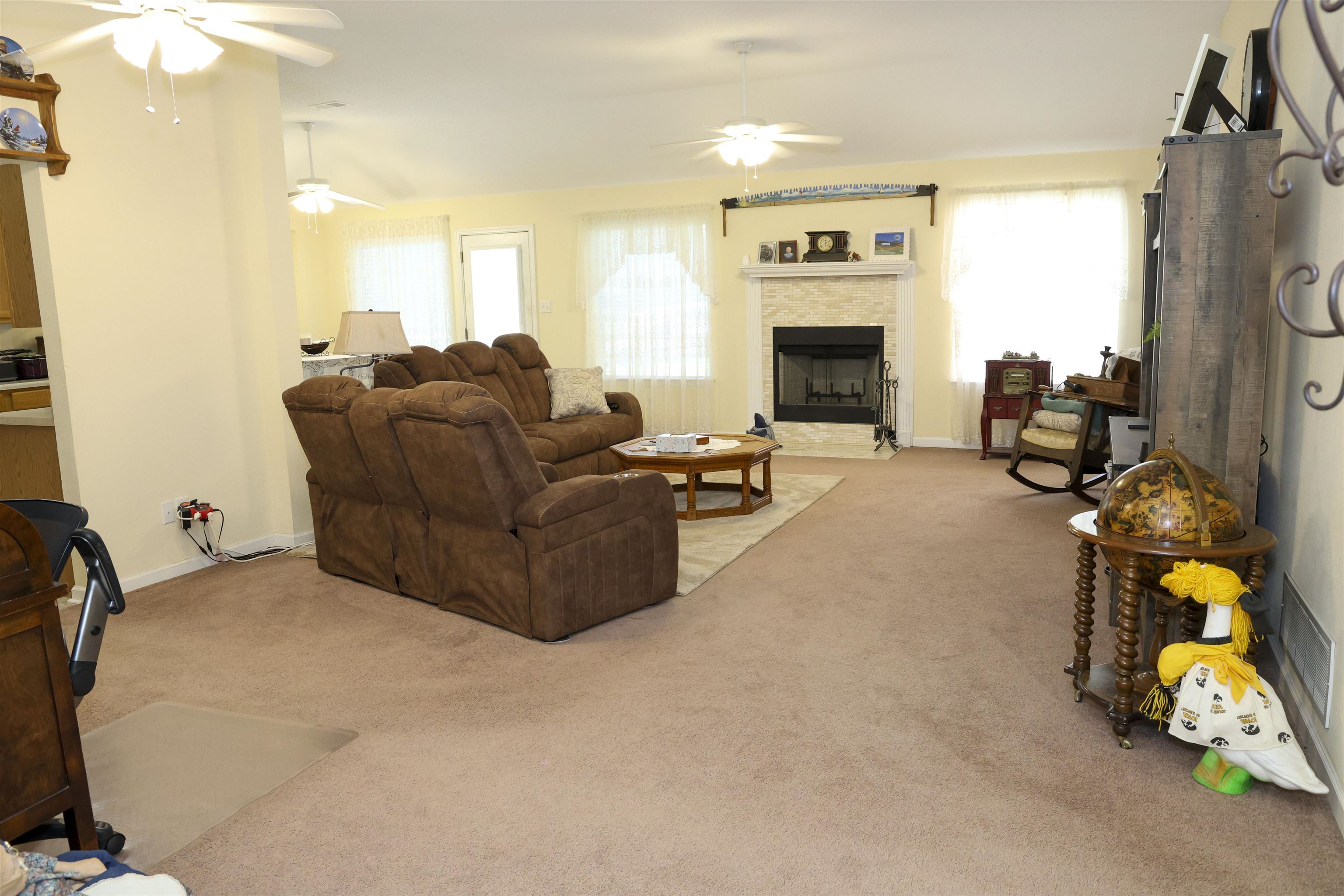 6626 Finch Road Memphis, TN 38141 - Photo 4 of 14 Spacious living area featuring neutral carpeting, a tiled fireplace with mantel, and multiple large windows