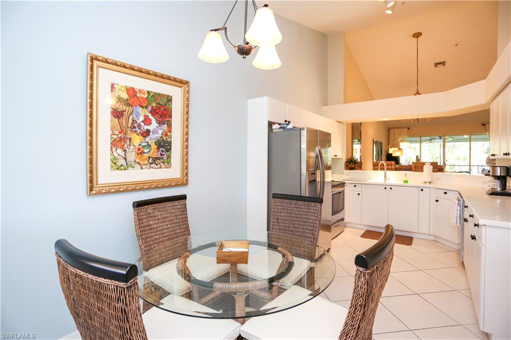 8175 Celeste Drive, Unit 1230 Naples, FL 34113 - Photo 11 of 35 a dining room with furniture a window and kitchen view
