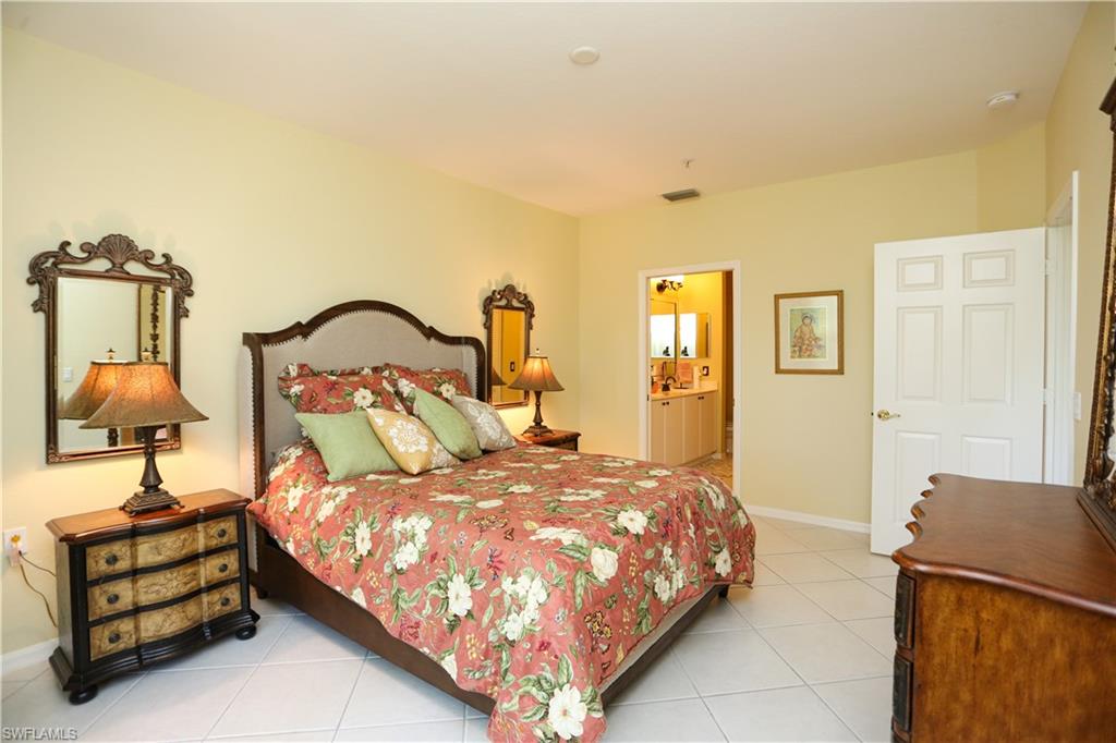 8175 Celeste Drive, Unit 1230 Naples, FL 34113 - Photo 16 of 35 a bedroom with a bed and wooden floor