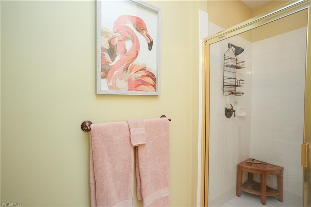 8175 Celeste Drive, Unit 1230 Naples, FL 34113 - Photo 20 of 35 a bathroom with a shower curtain
