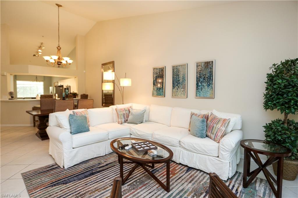 8175 Celeste Drive, Unit 1230 Naples, FL 34113 - Photo 2 of 35 a living room with furniture and a chandelier
