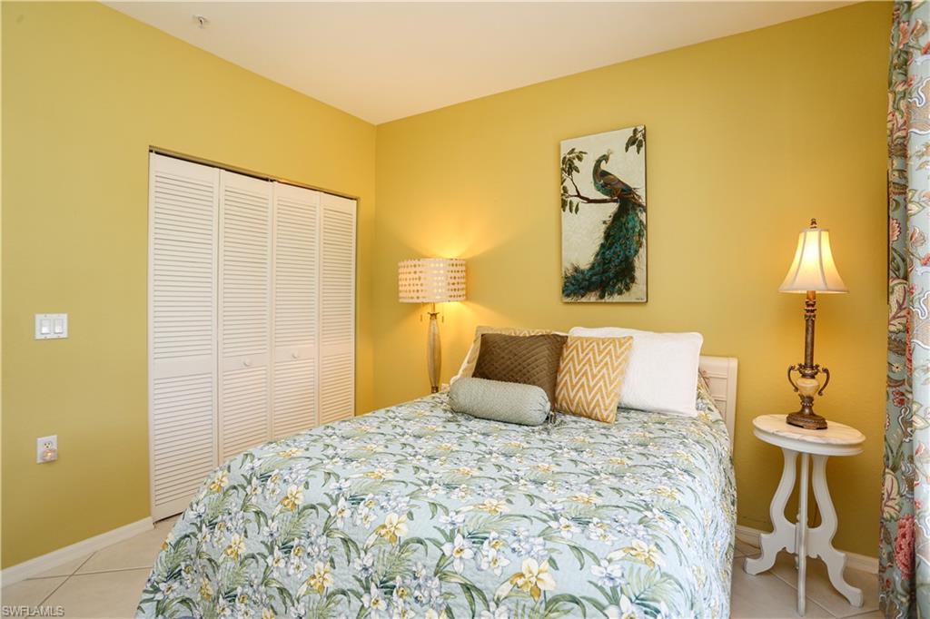 8175 Celeste Drive, Unit 1230 Naples, FL 34113 - Photo 23 of 35 a bedroom with a bed and a painting on the wall