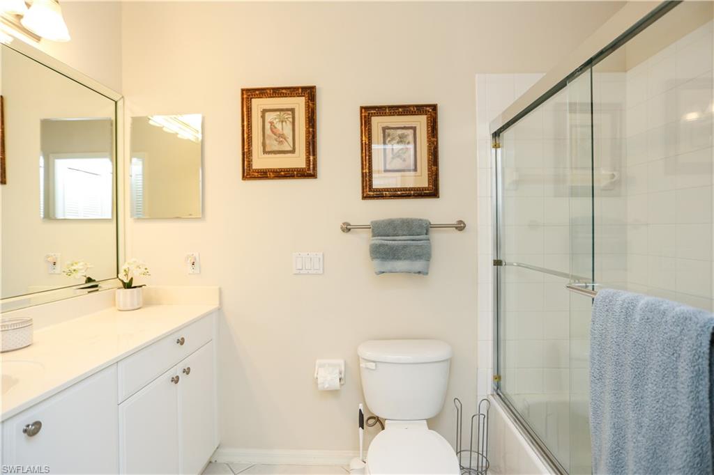 8175 Celeste Drive, Unit 1230 Naples, FL 34113 - Photo 25 of 35 a bathroom with a toilet sink and a mirror