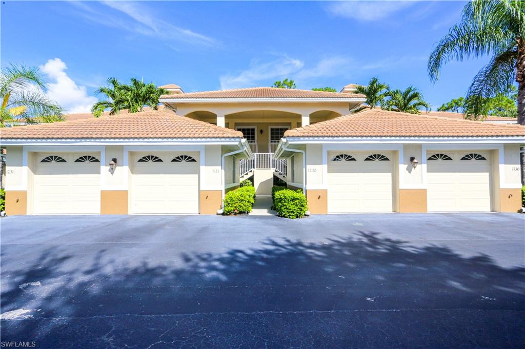 8175 Celeste Drive, Unit 1230 Naples, FL 34113 - Photo 31 of 35 a front view of a house with a yard and garage