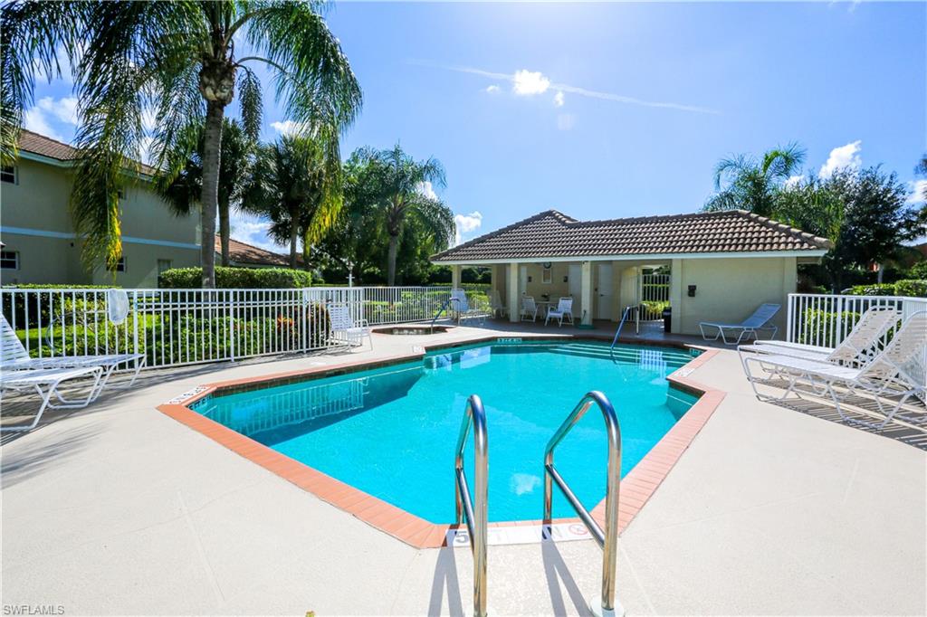 8175 Celeste Drive, Unit 1230 Naples, FL 34113 - Photo 35 of 35 a view of a patio with swimming pool table and chairs