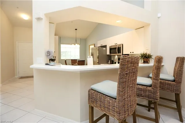 a dining room with furniture and a mirror