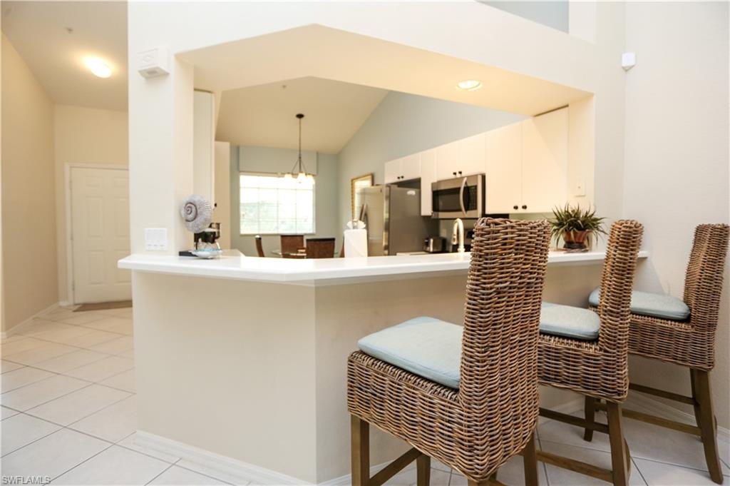 8175 Celeste Drive, Unit 1230 Naples, FL 34113 - Photo 6 of 35 a dining room with furniture and a mirror
