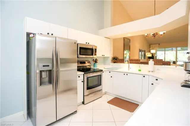 a kitchen with stainless steel appliances a refrigerator sink and microwave