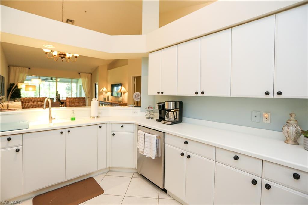 8175 Celeste Drive, Unit 1230 Naples, FL 34113 - Photo 9 of 35 a kitchen with white cabinets and sink