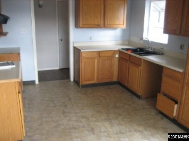 1915 Gridley Avenue Reno, NV 89503 - Photo 2 of 3 a kitchen with a sink stove and cabinets