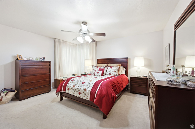 776 Flint Street Layton, UT 84041 - Photo 13 of 41 Spacious bedroom featuring light-toned carpet flooring, white walls, and a ceiling fan with integrated lighting