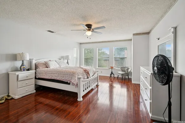 a bedroom with furniture and a wooden floor