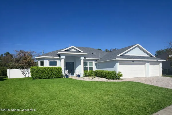a kitchen with stainless steel appliances kitchen island granite countertop a table chairs stove and refrigerator