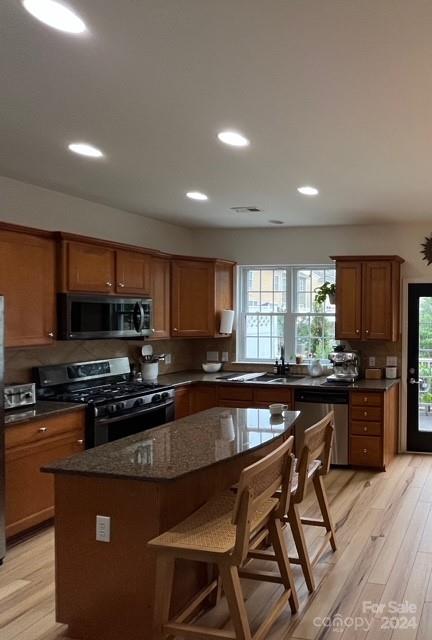 627 6th Baxter Crossing Fort Mill, SC 29708 - Photo 3 of 6 a kitchen with stainless steel appliances a stove a sink a microwave a refrigerator a stove a dining table and chairs