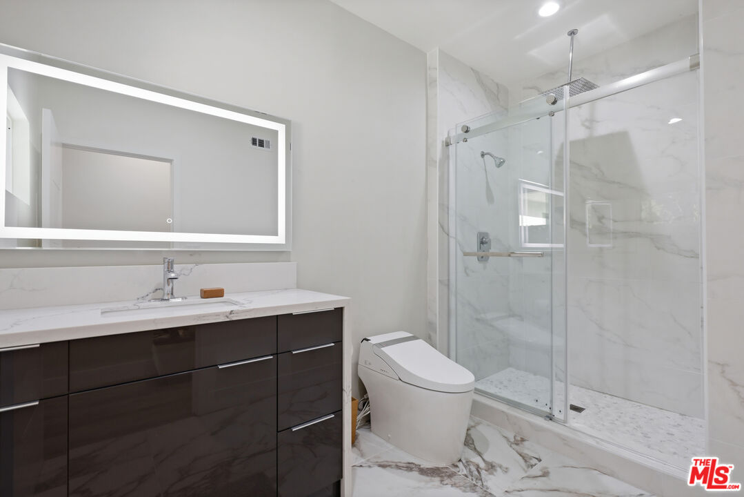 53 Saddlebow Road Bell Canyon, CA 91307 - Photo 50 of 66 a bathroom with a sink toilet a mirror and shower