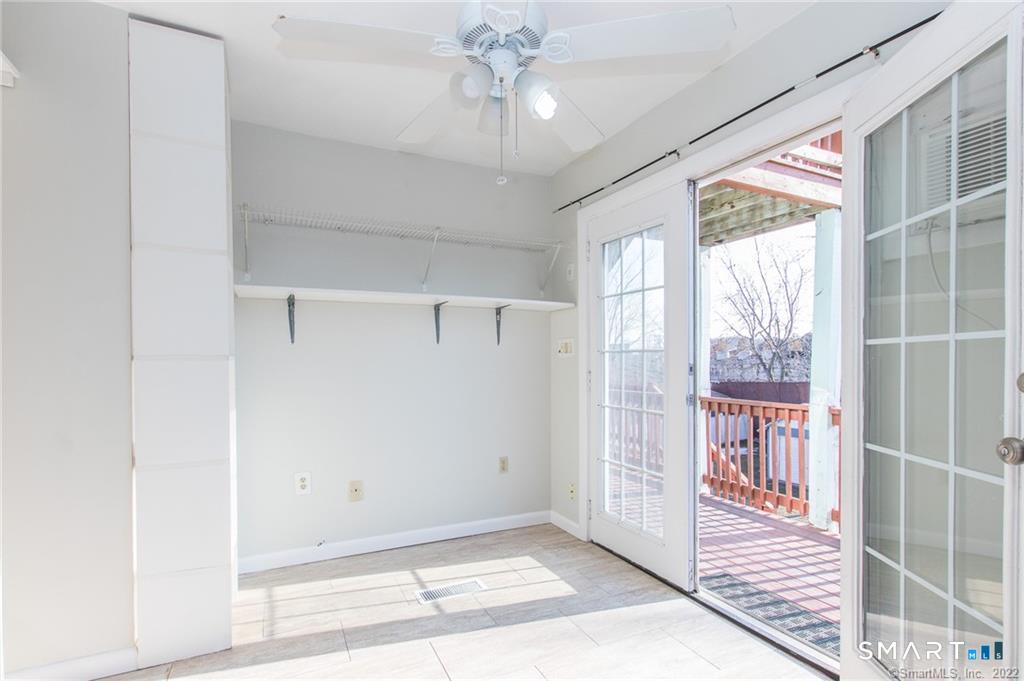 18 Lawrence Street Norwalk, CT 06854 - Photo 24 of 31 a view of a hallway with windows and chandelier fan