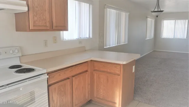 a kitchen with a cabinets and white appliances