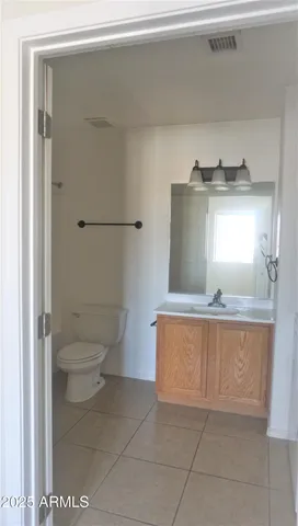 a bathroom with a toilet sink and a mirror