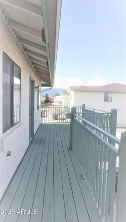 a view of balcony with wooden floor