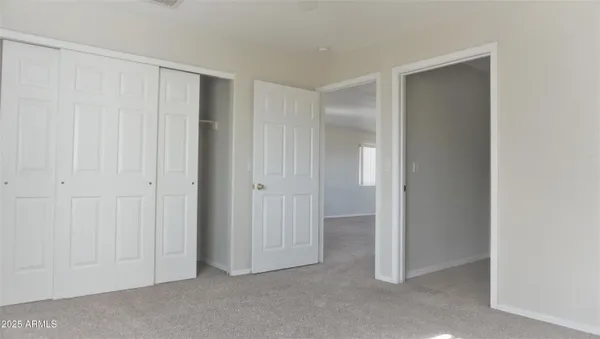 a view of an empty room with closet area