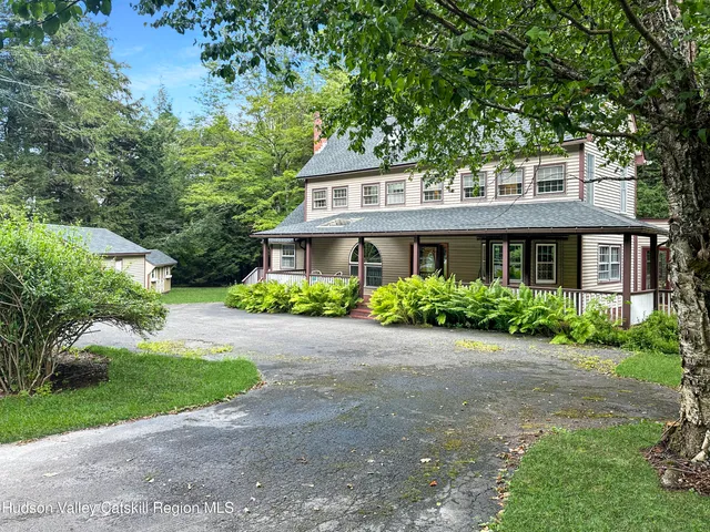 a front view of a house with a garden and porch