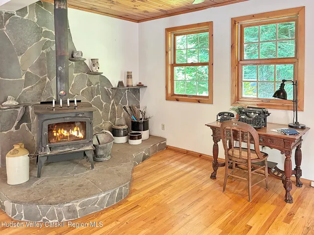 a view of a livingroom with furniture and a window