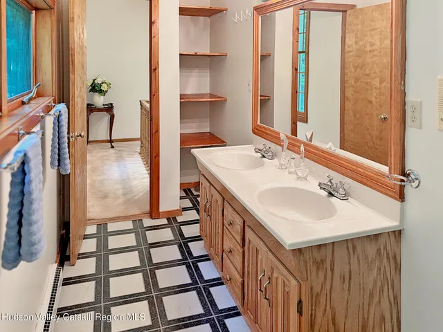 a bathroom with a sink a toilet and a window