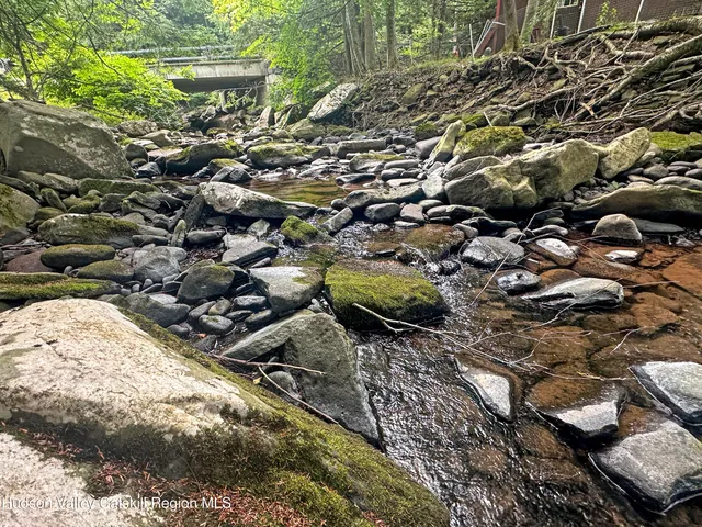 a view of two chairs and table in the balcony