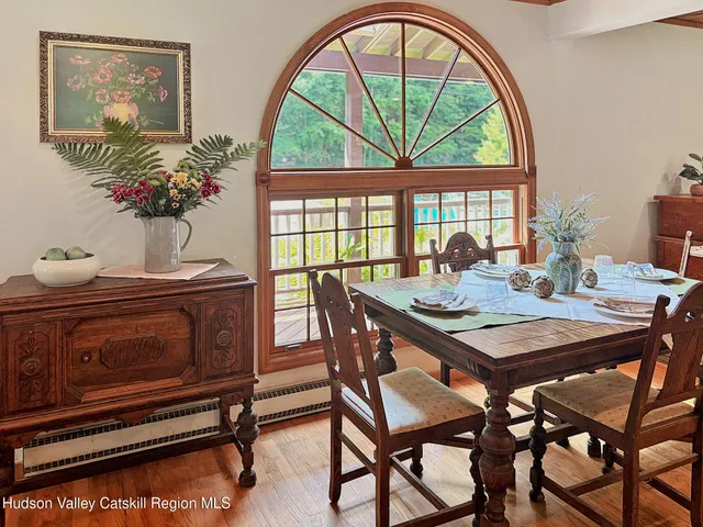 a view of a dining room with furniture a chandelier and wooden floor