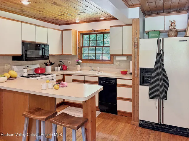 a kitchen with a sink appliances and cabinets