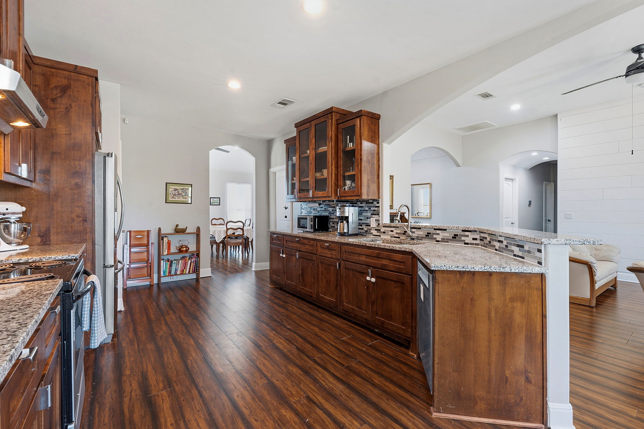 574 Highland Ranch Way Dale, TX 78616 - Photo 11 of 27 a large kitchen with a wooden floor and cabinets