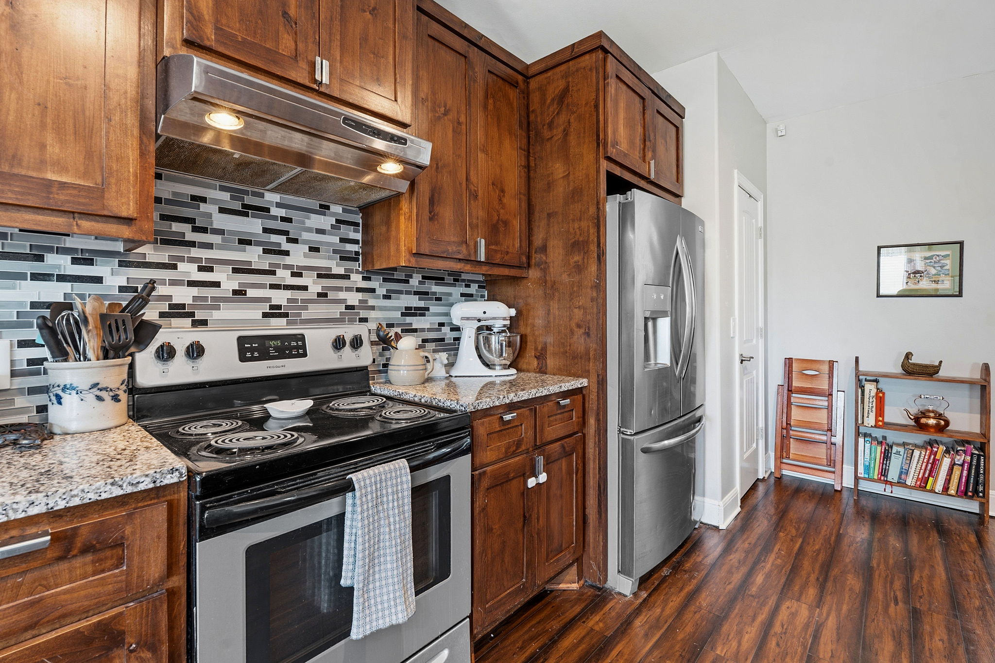 574 Highland Ranch Way Dale, TX 78616 - Photo 12 of 27 a kitchen with granite countertop a stove and a refrigerator