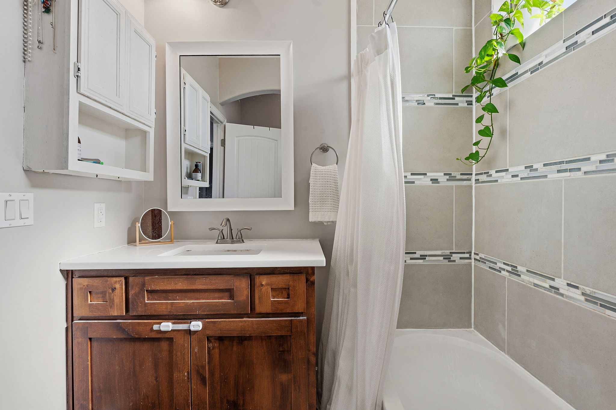 574 Highland Ranch Way Dale, TX 78616 - Photo 18 of 27 a bathroom with a granite countertop sink a mirror and a shower